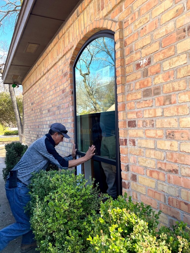 A-man-installing-energy-efficient-picture-replacement-windows-in-jacksonville-beach-fl